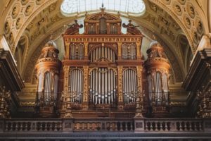 a large pipe organ in a church with a skylight